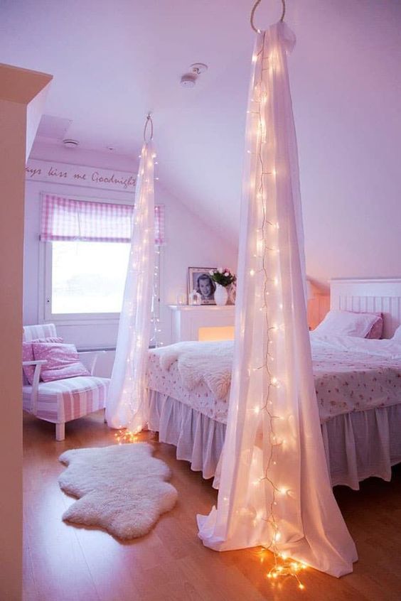 string lights attached to the fabric curtains for a cool look and to highlight the sleeping space