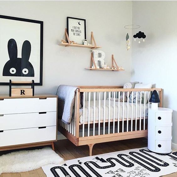a modern black and white nursery with light-colored wood touches is a chic and stylish idea