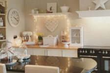 21 a small shelf with string lights that add interest to the space and make it fresher