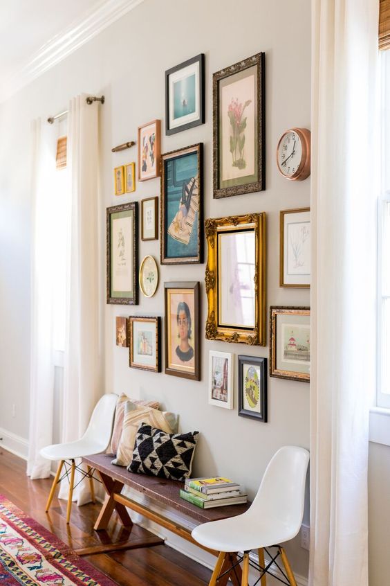 a vintage gallery wall with mismatching frames and various artworks