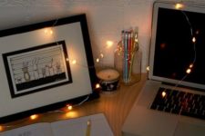 22 some string lights put right on teh desk to make it shine and inspire you
