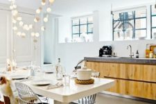 23 fun string lights hanging over the dining space in the kitchen to accent it