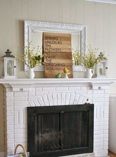 a wooden sign, blooming branches in jugs and faux birds to feel the spring