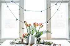 25 hang string lights over the dining space to separate it from the kitchen itself