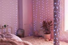 26 galaxy string lights coverign the walls and beams of a small bedroom to fill it with light