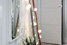 28 a ladder for storage covered with string lights