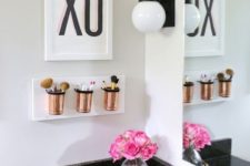 28 a small wall-mounted bathroom organizer with copper jars for makeup stuff