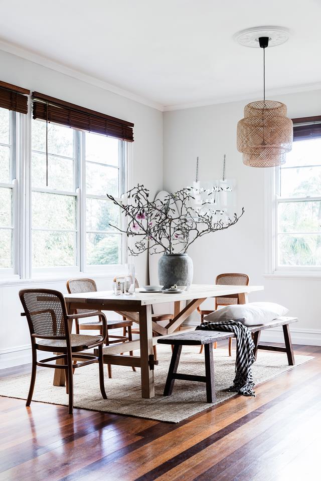 A formal dining space with wooden Roman shades, a woven lamp and comfy furniture is necessary for receiving guests