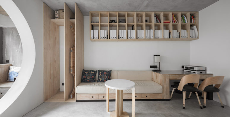 stylish wall mount storage solution The living room features a unit that combines a sofa, desk and a storage cabinet