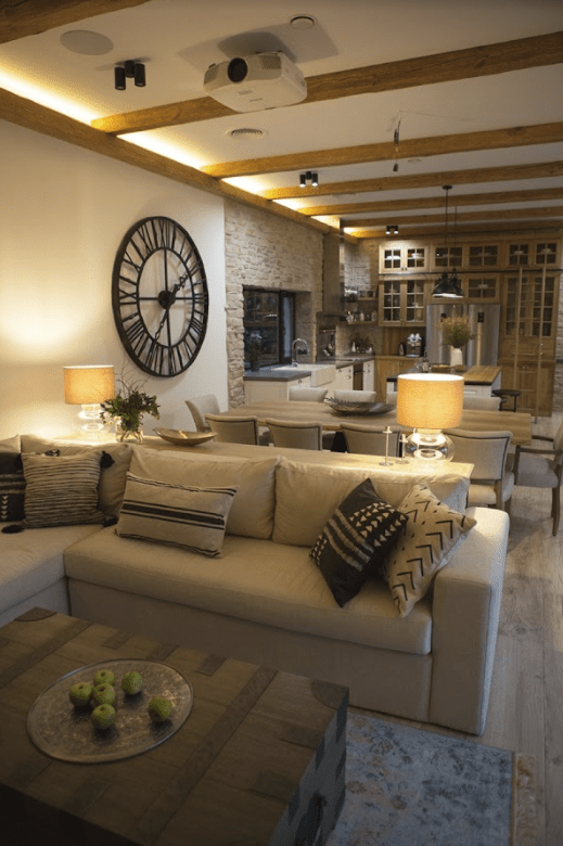 The main open layout includes a kitchen, living room and dining space, there are decorative wooden beams on the floor The main open layout includes a kitchen, living room and dining space, there are decorative wooden beams on the floor