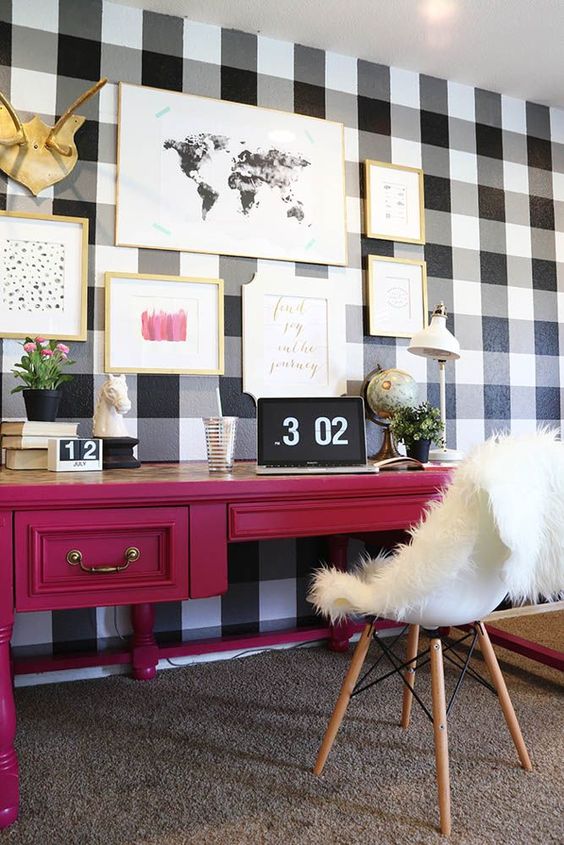 a statement buffalo check wall to define the home office and contrast the girlish decor