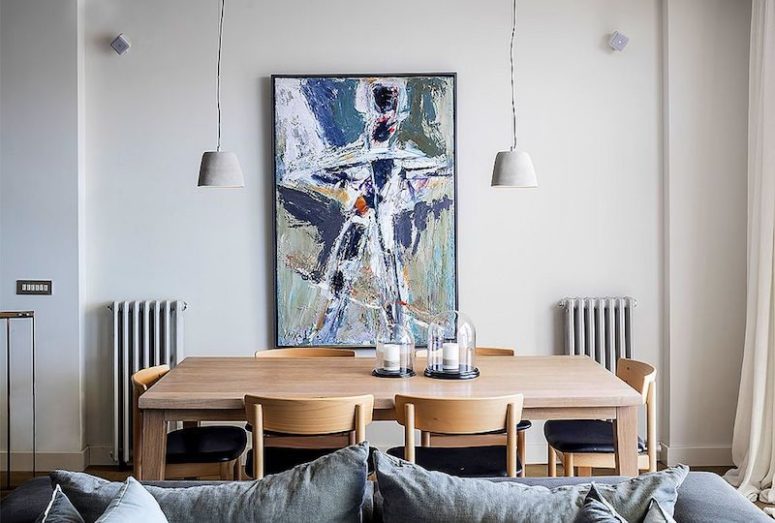 The dining space is part of the social zone and is done with a minimal wooden dining set and an abstract artwork The dining space is part of the social zone and is done with a minimal wooden dining set and an abstract artwork