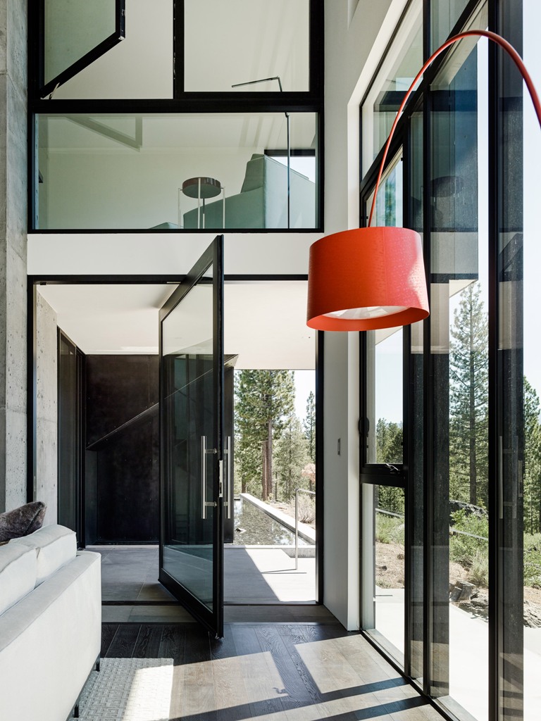 There's much glazing in the home to let natural light in, the glass used is dark to prevent excessive sunlight, and even the doors are pivot to make the house more seamless