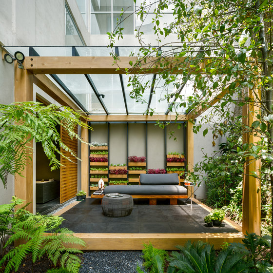 This is one of the terraces with a vertical garden and a modern Asian-like bench