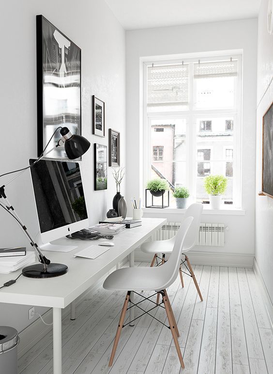 a black and white gallery wall over the desk gives more style to the space