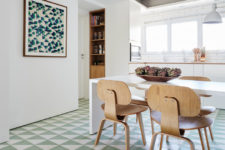 04 The floors are clad with geometric tiles in green and white, and there’s a matching artwork