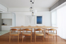 05 There’s a large dining space with a long table and chairs and a large window with a curtain that brings privacy
