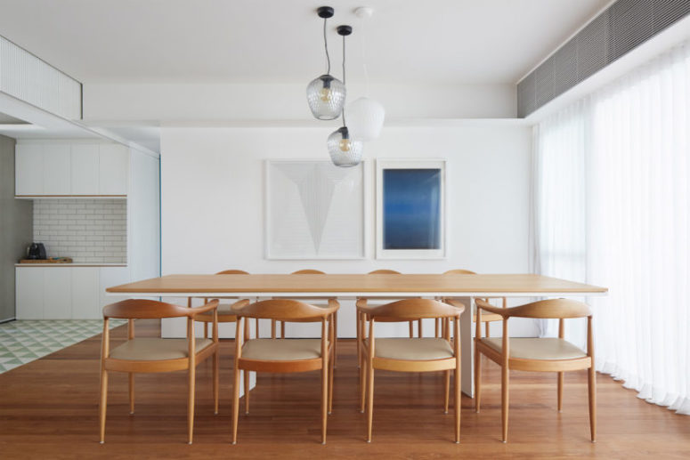 There's a large dining space with a long table and chairs and a large window with a curtain that brings privacy There's a large dining space with a long table and chairs and a large window with a curtain that brings privacy