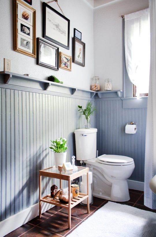 a modern farmhouse bathroom with tall powder blue wainscoting for adding color to the space