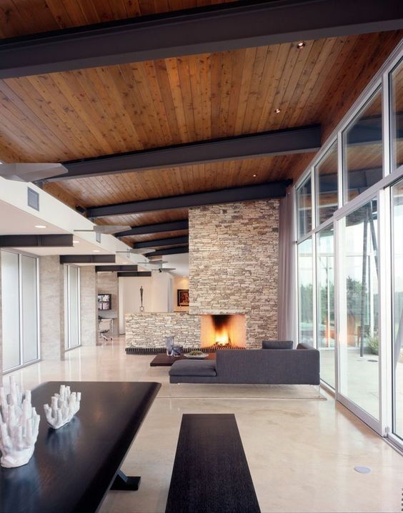 a modern rich colored wooden ceiling with black metal ceiling beams for a minimalist look