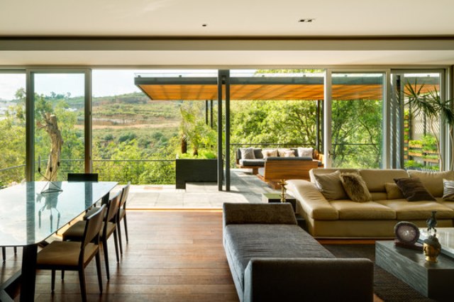 The restraint color palette of ivory, grey and rhich wood tones is used both indoors and outdoors to conenct the spaces even more The restraint color palette of ivory, grey and rhich wood tones is used both indoors and outdoors to conenct the spaces even more