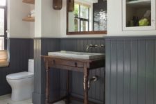 06 a farmhouse bathroom with graphite grey wainscoting that matches the floor tiles