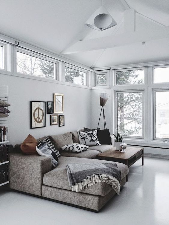 a grey L shaped sofa continues the peaceful theme of decor and adds coziness with textural upholstery a grey L-shaped sofa continues the peaceful theme of decor and adds coziness with textural upholstery