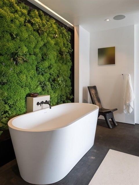 a moss living wall in the bathroom is a gorgeous feature that adds a spa feel instantly