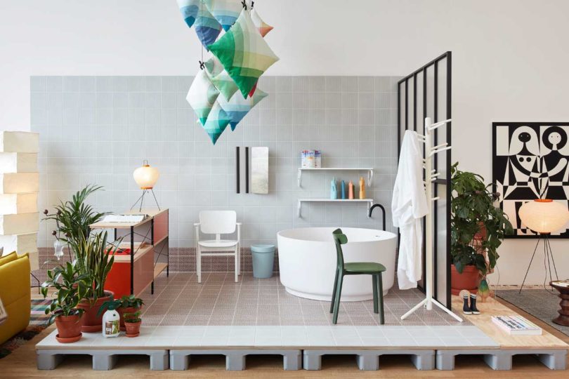 The bathroom is open, with colorful pillows installation over it and modern appliances