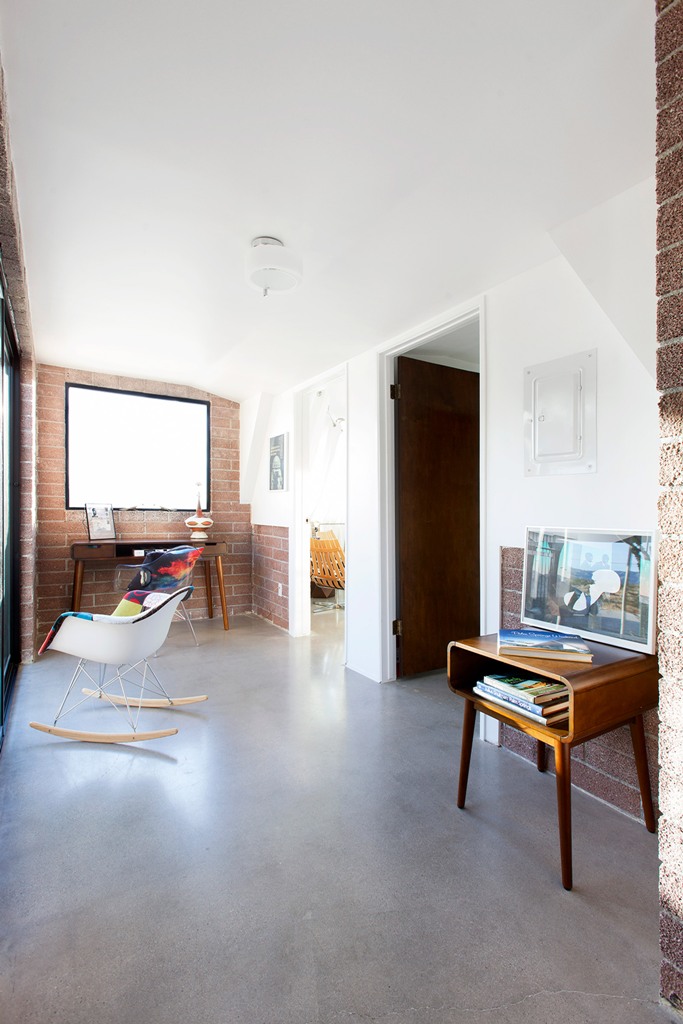 home office with brick walls The home office is done with brick walls, mid-century modern furniture and is filled with natural light