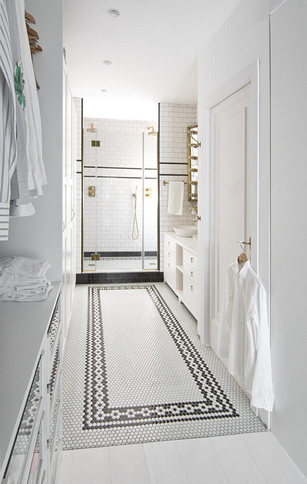 The master bathroom is done with black and white tiles and some brass touches for an elegant vintage feel The master bathroom is done with black and white tiles and some brass touches for an elegant vintage feel