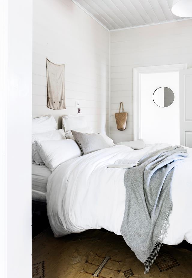 The master bedroom is a peaceful space with a large bed, a vintage rug and some accessories here and there The master bedroom is a peaceful space with a large bed, a vintage rug and some accessories here and there