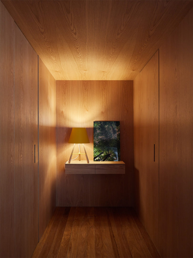 This is a small entryway completely clad in wood, it features doors to the powder room and exit
