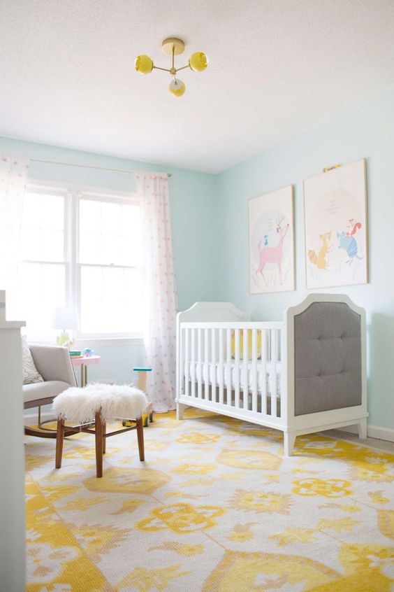 a yellow printed rug and chandelier are a nice idea to add color to the room