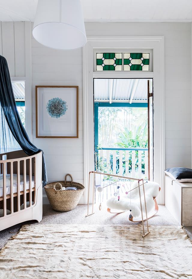 The nursery shows off a stunning modern crib with a dark canopy, some matching navy touches and cozy accessories The nursery shows off a stunning modern crib with a dark canopy, some matching navy touches and cozy accessories