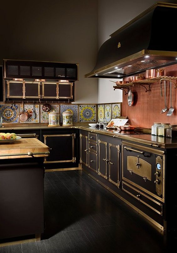 a Victorian steampunk inspired kitchen with a colorful tile backsplash and a copper one over the cooker