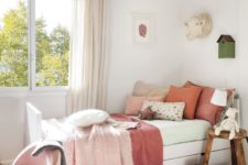 10 The girls’ bedroom is done in red and pinks, with layered textiles and some rustic touches