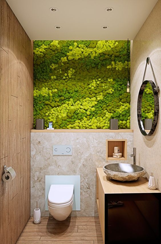 a small powder room is made more eye-catchy with a chic moss wall in several shades