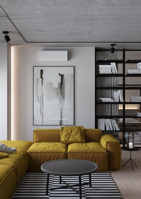 a yellow L-shaped sectional sofa adds color to this monochrome space and makes it shine