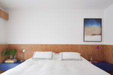 The master bedroom is done in white, light-colored wood and with blue touches