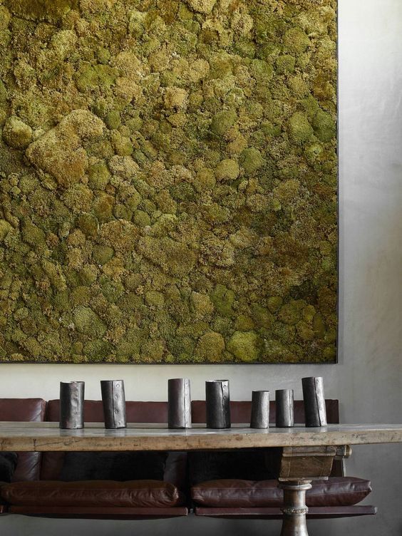 an oversized moss wall art in the dining room makes a bold statement