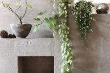13 enliven the concrete fireplace with climbing plants hanging from the mantel