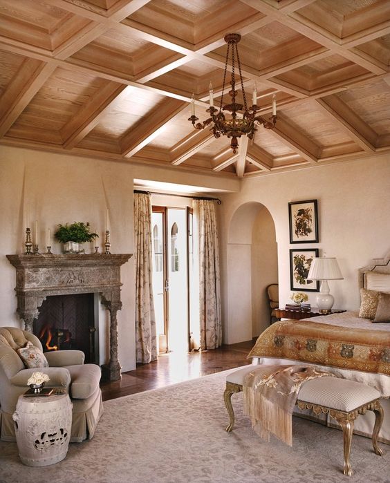 a coffered wooden ceiling makes this refined bedroom complete and brings warmth to the space
