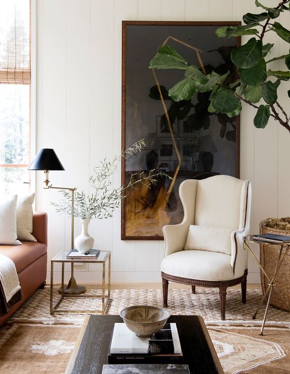 a creamy wingback adds a chic and elegant touch to the space and is a comfy furniture piece