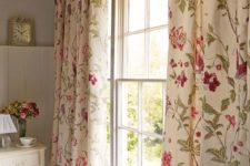 16 ivory curtains with fuchsia and green floral prints add a refined vintage feel to the space