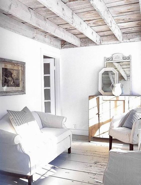 a whitewashed reclaimed wood ceiling with beams perfectly fits a shabby chic beach space
