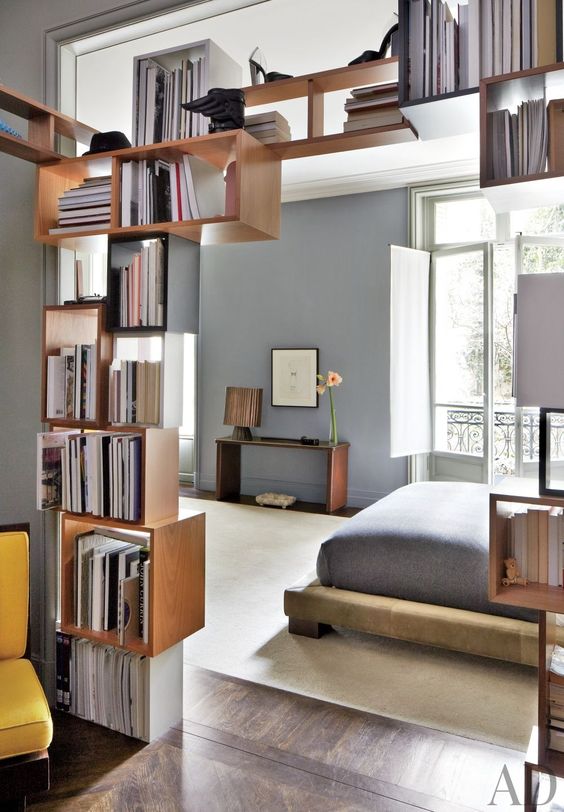 box-shaped shelves partly covering the entrance to the bedroom is a nice solution