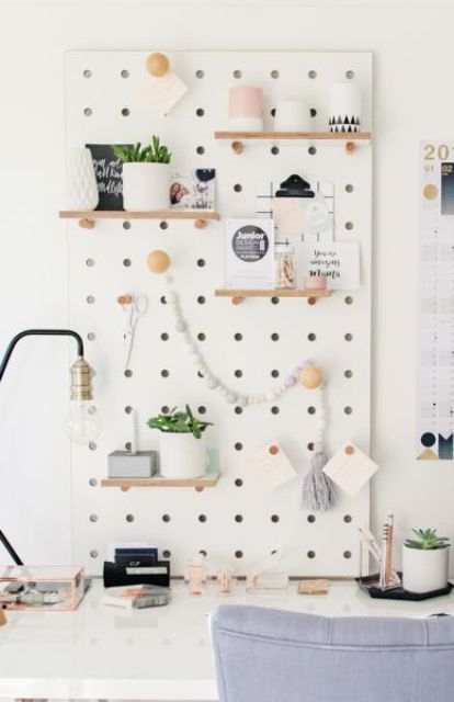 a white pegboard with shelves is a great piece that will accomodate a lot of things