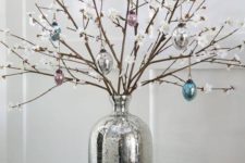 19 style your console with faux cherry blossom branches and glass egg ornaments plus colorful ones in a wooden bowl
