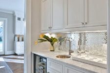 20 a silver tile backsplash adds glam and a cute touch to the space